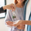 Young Asian couple receiving new apartment or room key from real